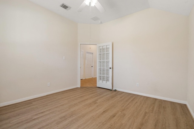 spare room featuring baseboards, visible vents, ceiling fan, and light wood finished floors