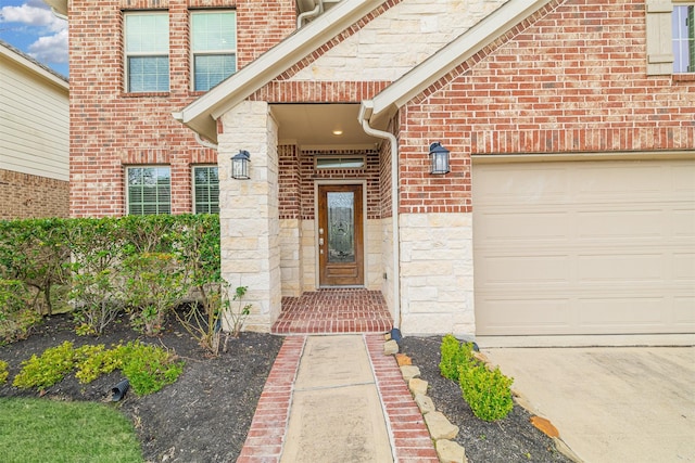 property entrance with an attached garage, stone siding, and brick siding