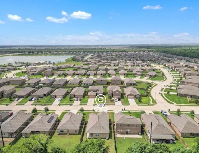 drone / aerial view with a water view and a residential view