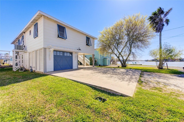 view of front of property featuring an attached garage, concrete driveway, stairway, a carport, and a front yard