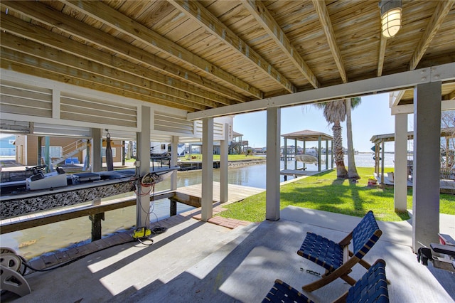 view of patio featuring a dock, a water view, and boat lift