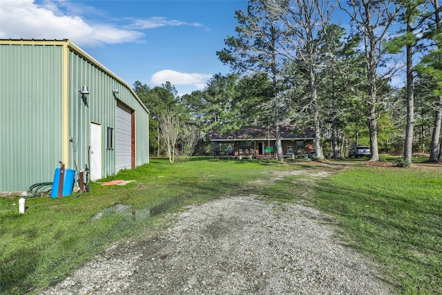 view of yard featuring an outbuilding and a detached garage