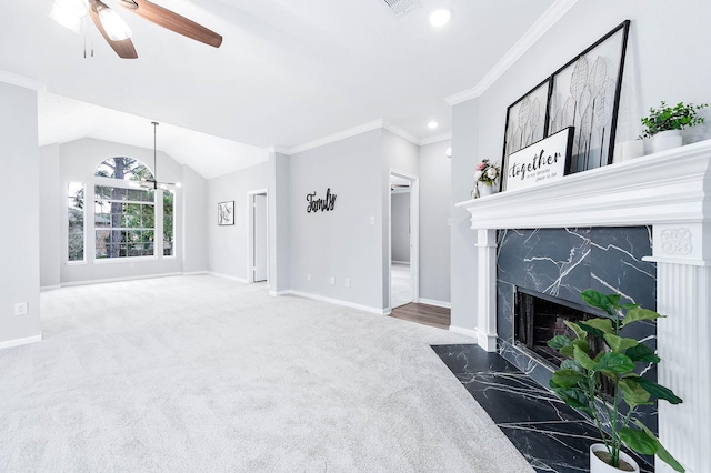 carpeted living room featuring baseboards, a ceiling fan, ornamental molding, vaulted ceiling, and a high end fireplace