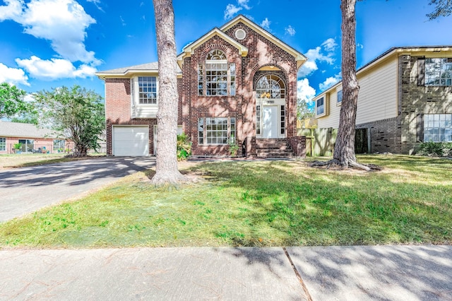 view of front facade with a garage, driveway, brick siding, and a front yard