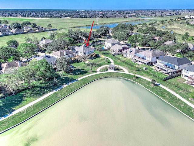 birds eye view of property with a water view and a residential view