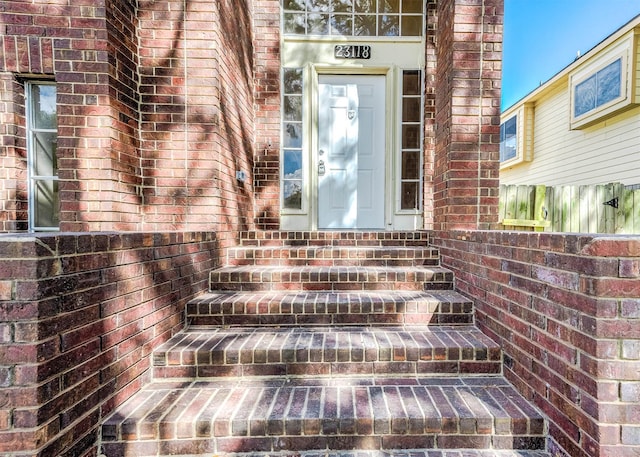 doorway to property with brick siding