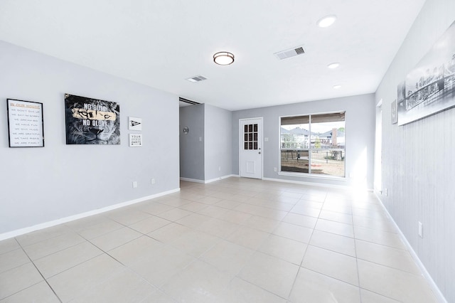 empty room featuring light tile patterned floors, recessed lighting, visible vents, and baseboards