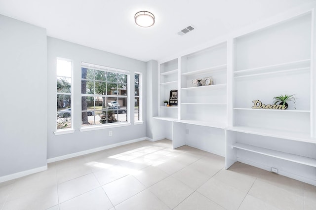 interior space with visible vents, baseboards, and light tile patterned floors