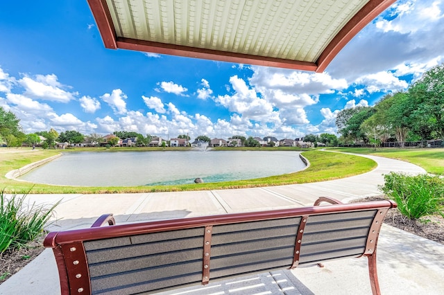 surrounding community featuring a water view and a yard