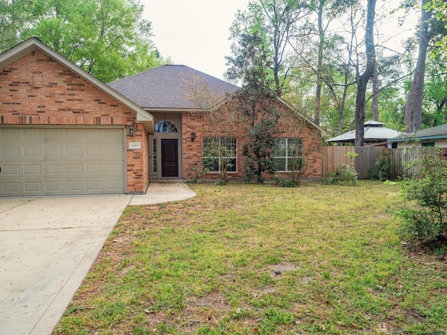 ranch-style house with concrete driveway, brick siding, fence, and a front lawn