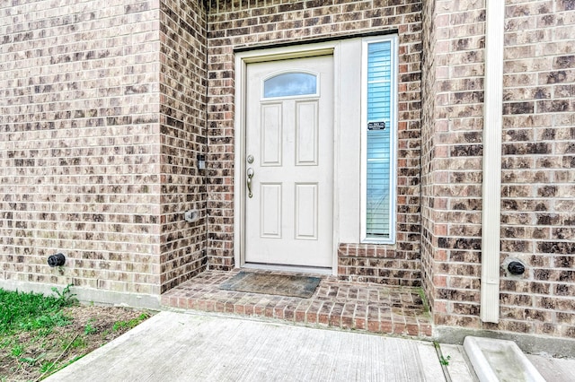 property entrance with brick siding