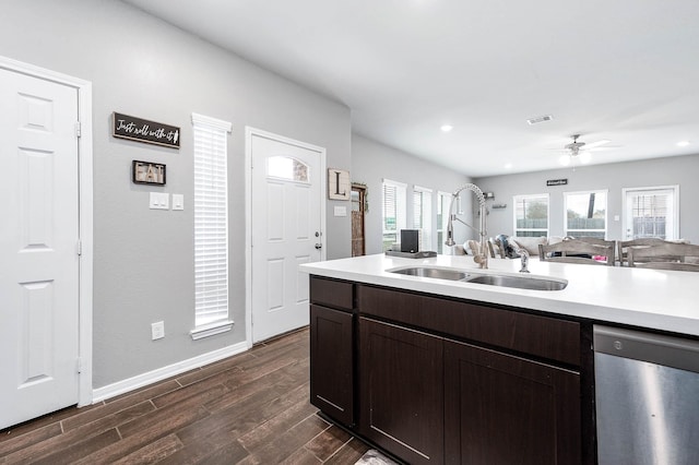 kitchen with dark wood-style floors, visible vents, a sink, light countertops, and stainless steel dishwasher