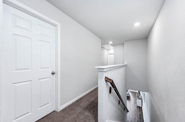 hallway with carpet, baseboards, attic access, an upstairs landing, and recessed lighting