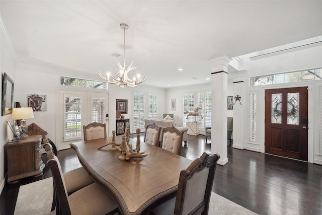 dining space with a notable chandelier, french doors, crown molding, visible vents, and dark wood finished floors