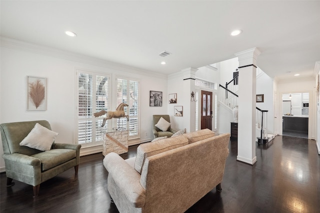 living area featuring visible vents, decorative columns, ornamental molding, stairs, and dark wood-type flooring