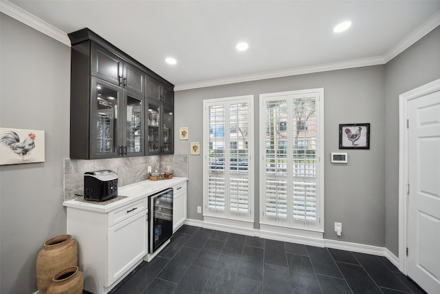 bar featuring a dry bar, beverage cooler, tasteful backsplash, and ornamental molding