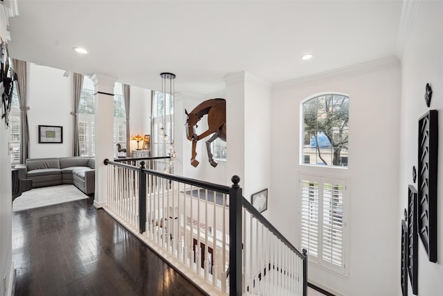 hallway with crown molding, decorative columns, an upstairs landing, recessed lighting, and wood finished floors