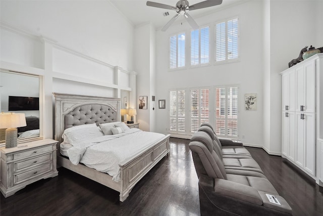 bedroom with baseboards, multiple windows, dark wood-style floors, and ornamental molding