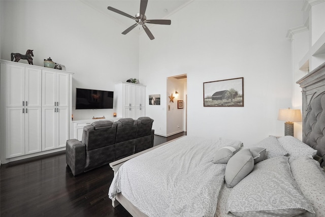 bedroom with dark wood-type flooring, high vaulted ceiling, and a ceiling fan
