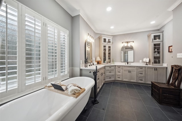 full bath featuring tile patterned floors, a soaking tub, a healthy amount of sunlight, and ornamental molding