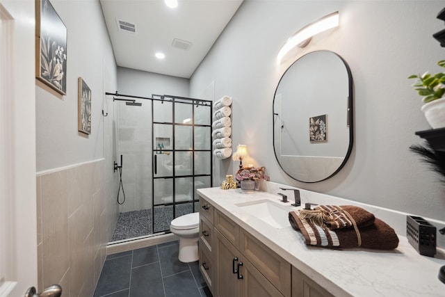 bathroom featuring tile patterned flooring, visible vents, a shower stall, toilet, and vanity