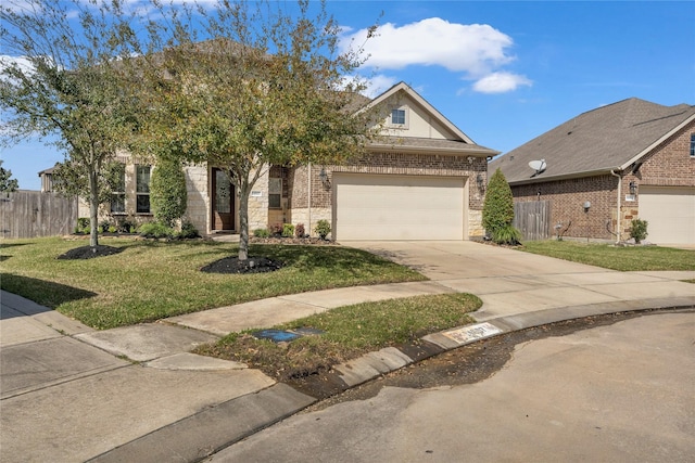 view of front of home featuring driveway, a garage, fence, and a front yard