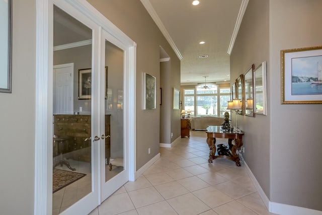 hall featuring ornamental molding, french doors, light tile patterned flooring, and baseboards