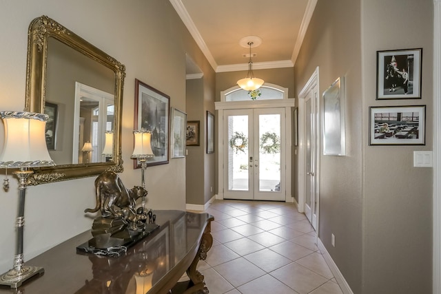 entrance foyer with ornamental molding, french doors, light tile patterned floors, and baseboards