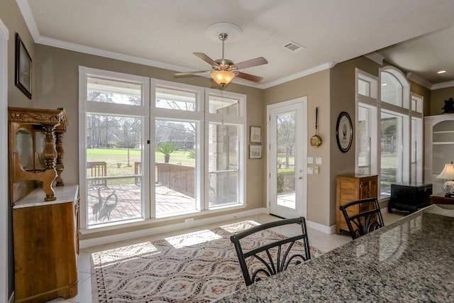 doorway to outside featuring visible vents, baseboards, a ceiling fan, ornamental molding, and light tile patterned flooring