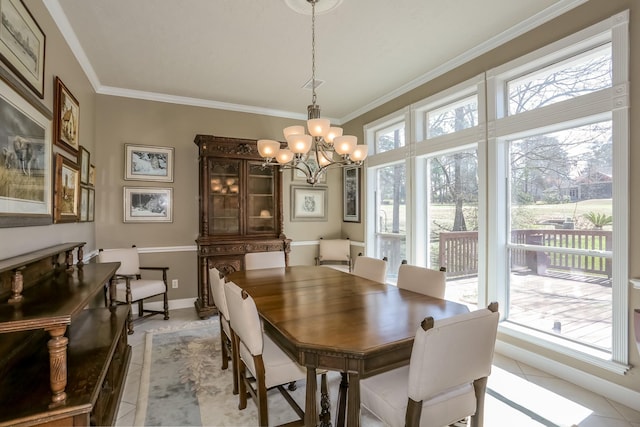 dining room featuring a chandelier, crown molding, baseboards, and light tile patterned floors