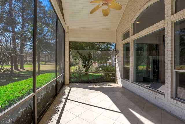 unfurnished sunroom with wood ceiling, vaulted ceiling, and ceiling fan