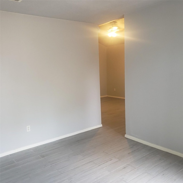 unfurnished room featuring wood finished floors and baseboards