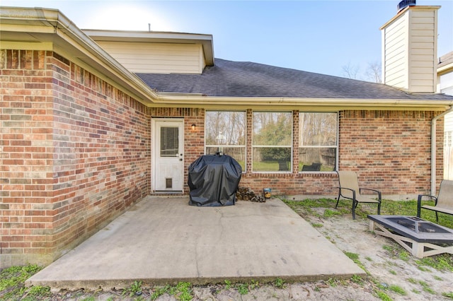 view of patio featuring a grill and a fire pit