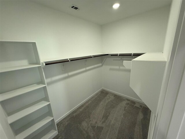 walk in closet featuring dark carpet and visible vents