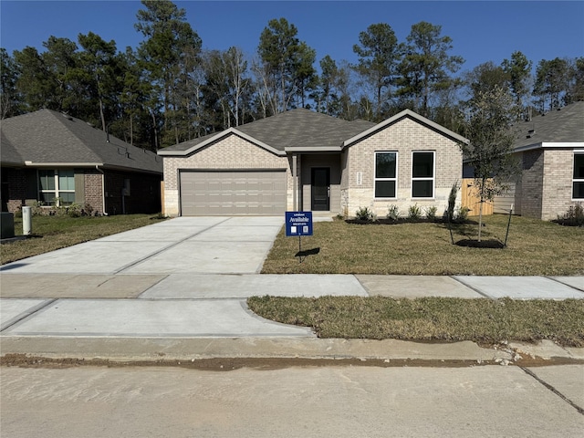 single story home with concrete driveway, a front lawn, an attached garage, and brick siding