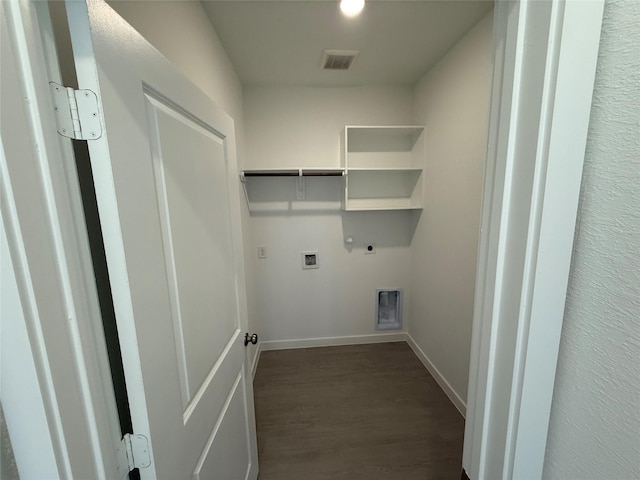 clothes washing area with dark wood-style flooring, hookup for a gas dryer, visible vents, electric dryer hookup, and laundry area