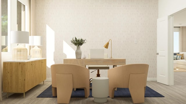 dining space with baseboards, light wood finished floors, and wallpapered walls