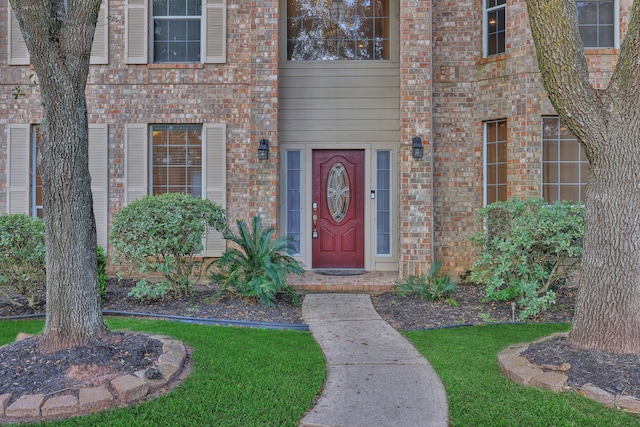 property entrance with brick siding