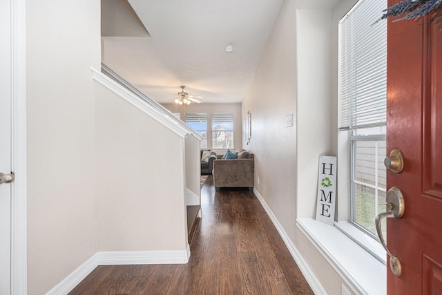 hall featuring dark wood finished floors and baseboards