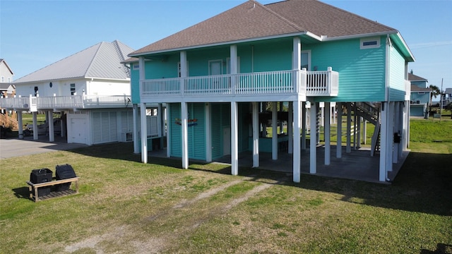 rear view of property with a carport, roof with shingles, a lawn, and driveway