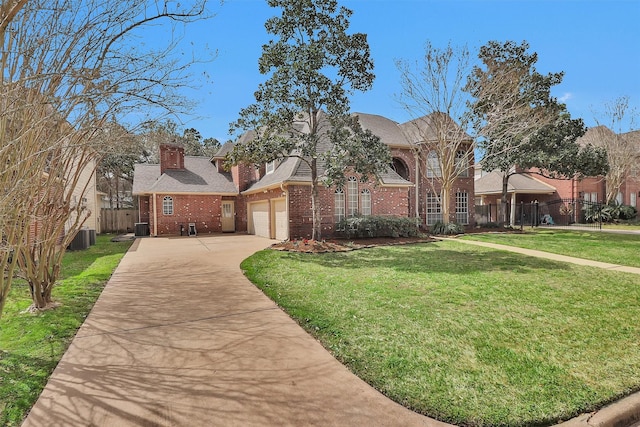 view of front of property with brick siding, fence, concrete driveway, a front lawn, and a chimney