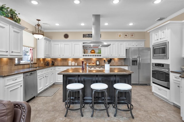 kitchen with stainless steel appliances, a kitchen island with sink, white cabinets, a sink, and island range hood