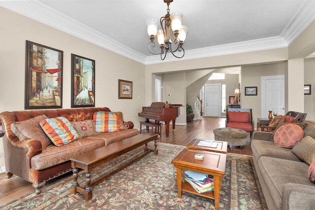 living room featuring crown molding, stairway, a notable chandelier, and wood finished floors