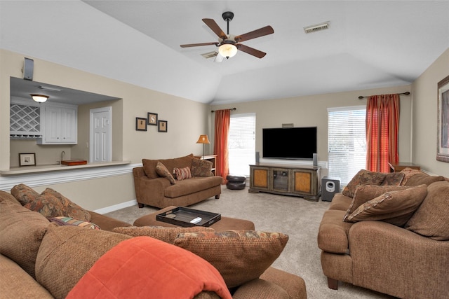 living area featuring plenty of natural light, visible vents, indoor wet bar, and light colored carpet