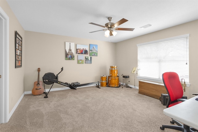 exercise room featuring baseboards, carpet, visible vents, and a ceiling fan