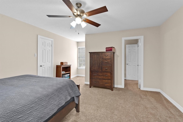 bedroom with baseboards, a ceiling fan, and light colored carpet