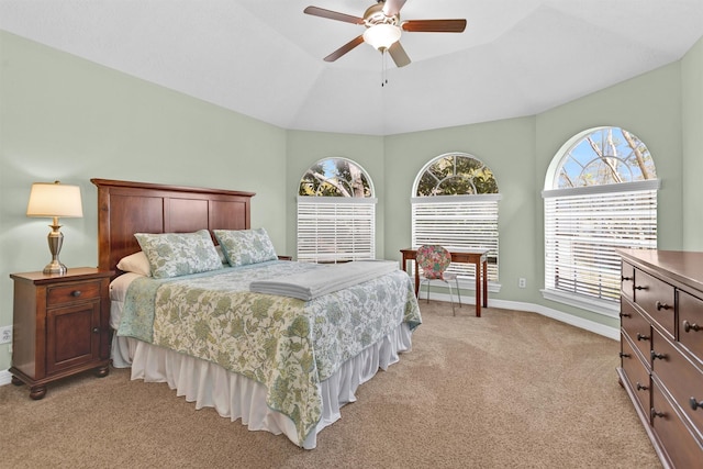 bedroom featuring a ceiling fan, light carpet, and baseboards