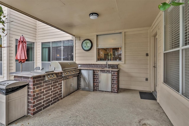 view of patio with a sink, exterior kitchen, and a grill