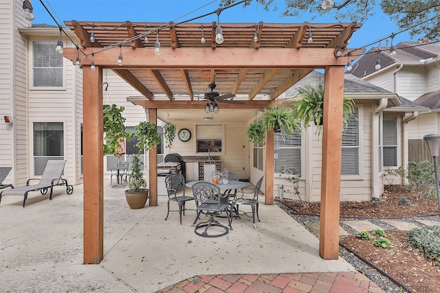 view of patio / terrace with outdoor dining space, a ceiling fan, and a pergola