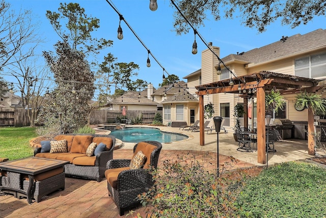 view of swimming pool featuring a patio, outdoor lounge area, an outdoor kitchen, a pergola, and a fenced backyard